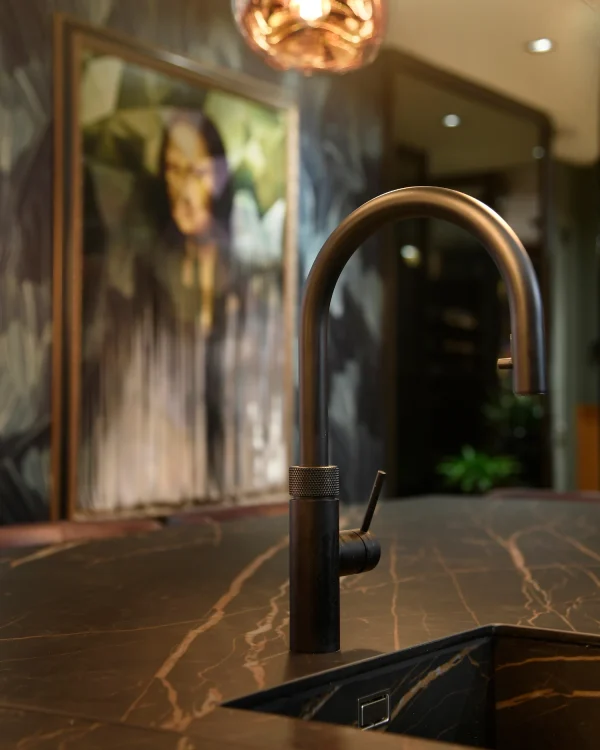 European custom home interiors featuring Laminam Noir Desir porcelain surfaces; luxurious deep black slabs with elegant ivory and gold veining, showcasing Italian craftsmanship and sophisticated design.