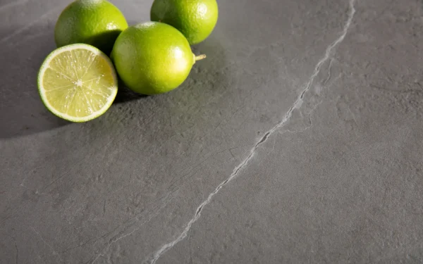Still life showcasing Laminam Pietra Grey Italian porcelain; smooth grey surface with fine white veining offering a modern and refined look.