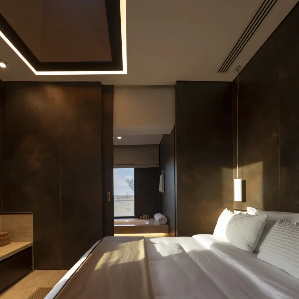 Luxury lodge interiors adorned with Laminam Ossido Bruno Italian porcelain; rich brown surfaces with textured finishes adding depth and warmth to the space.