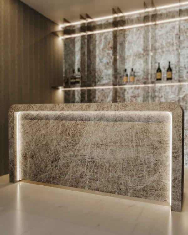 Leathered 2 cm Naica quartzite slab in gray and brown tones; showcased in a luxury showroom.